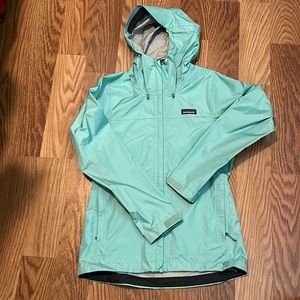 Extra small patagonia light weight rain jacket. It is a light blue/green.